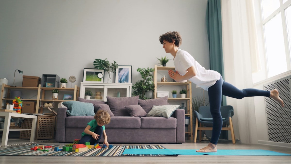 a woman and a child playing in a living room